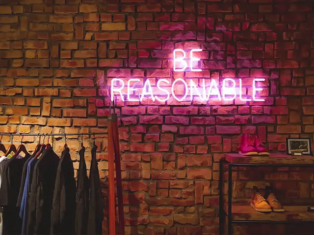Picture of a sign saying "Be Reasonable" 
