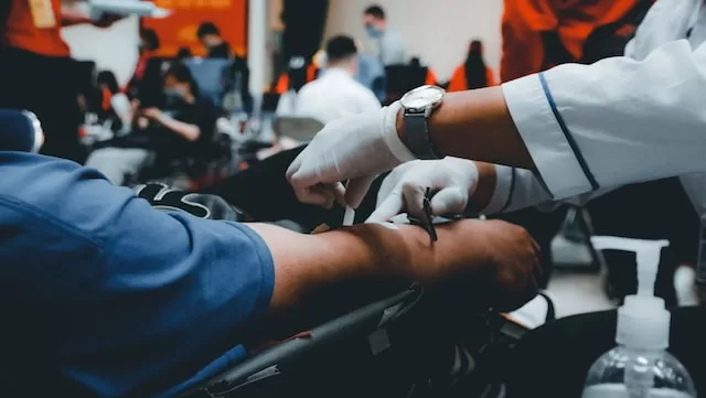 Picture of a person donating blood to a medical facility 
