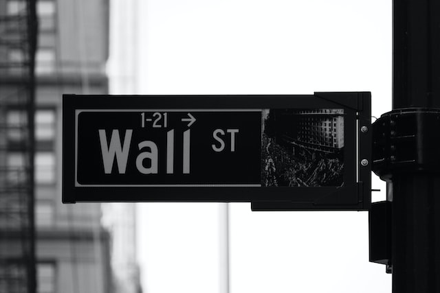 Picture of a street sign saying "Wall Street" 