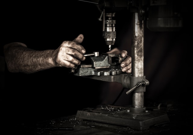 Picture of a machinists working on  a lathe  