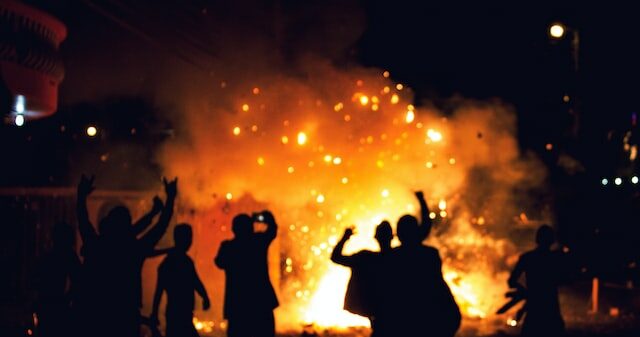Picture of people partying around a bonfire