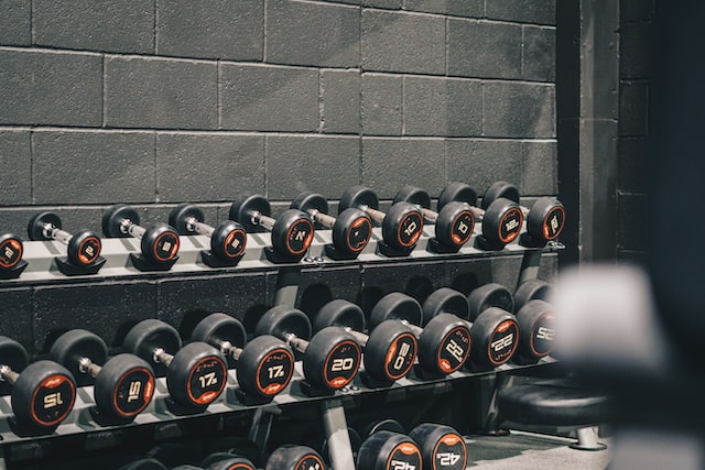 Pictures of dumbbells of different weights stacked in a gym