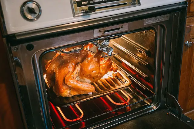 picture of a chicken being heated in an oven