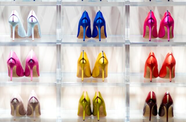 picture of a shoe rack full of different colored stilettos