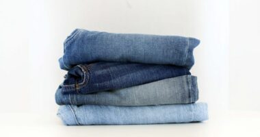 Picture of different styles of jeans put on display on in a store