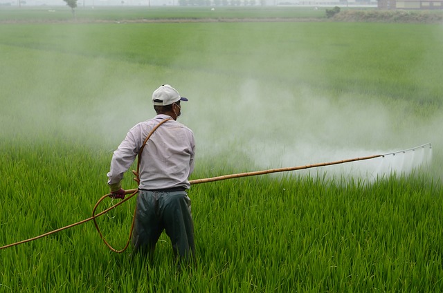 picture of a farmer using herbicides on his crops