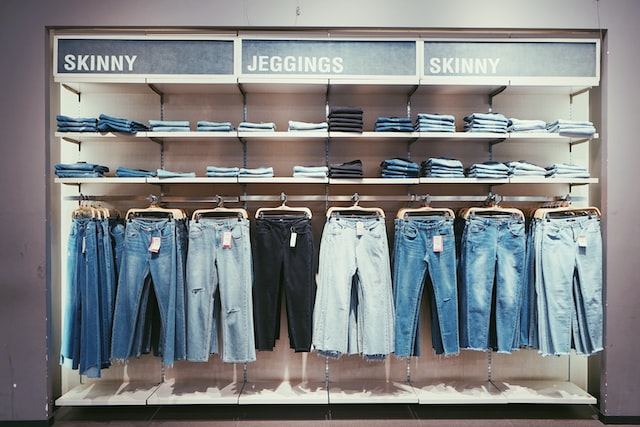 Picture of different styles of jeans put on display in a store