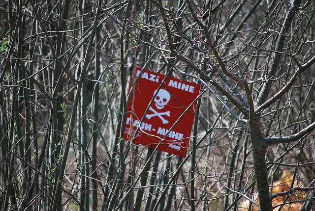 Picture of a sign board warning people of a minefield 