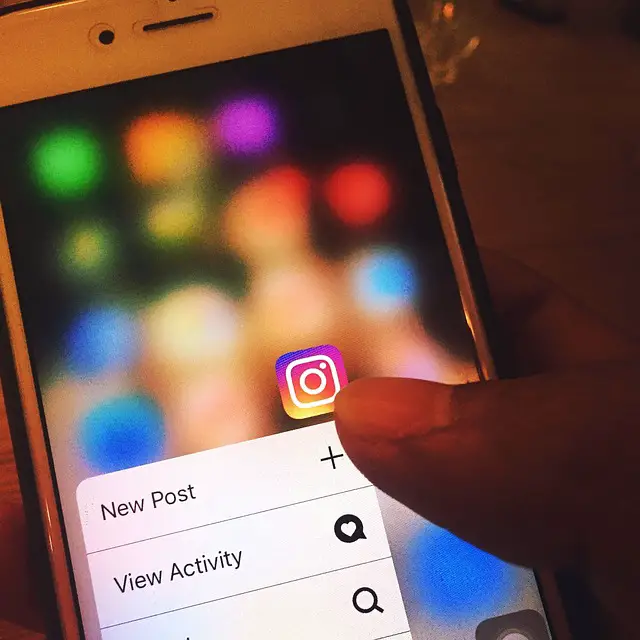picture of person holding a phone with Instagram app open on it