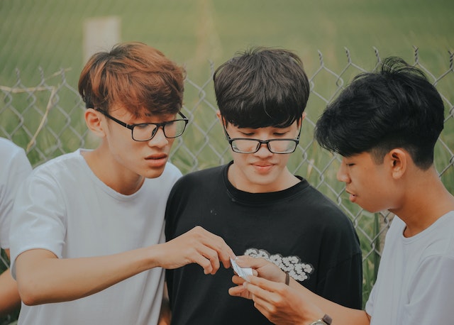 Picture of three young boys looking at something