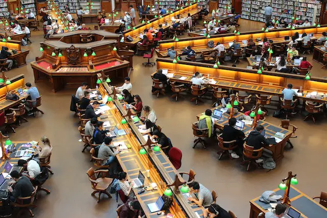 picture of students studying in a large library 