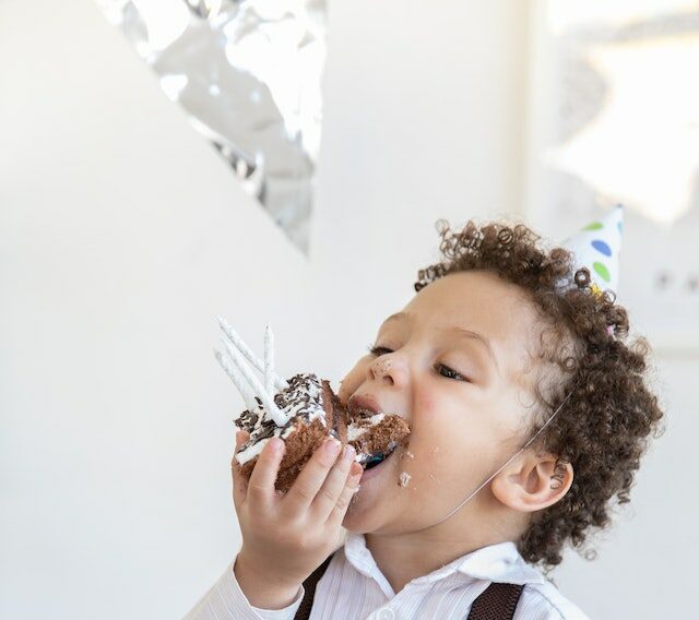 Picture of small child eating cake