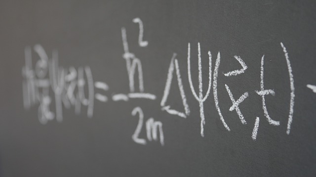 Picture of a mathematical theory written on a black board 