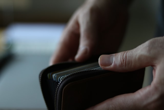 Picture of a person opening a wallet
