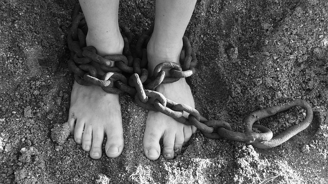 Picture of a person who's legs are bound in chains