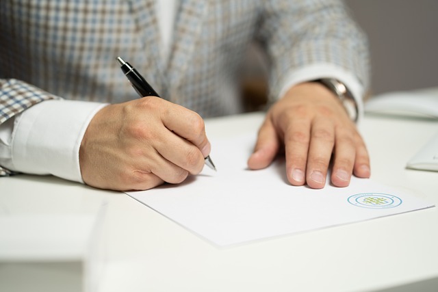 Picture of a person signing a document