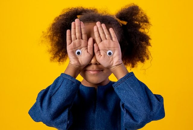 Picture of a little girl covering her eyes