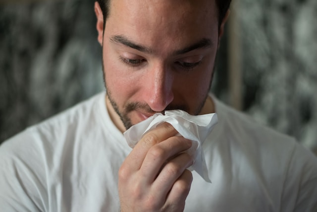 Picture of a person with a tissue 