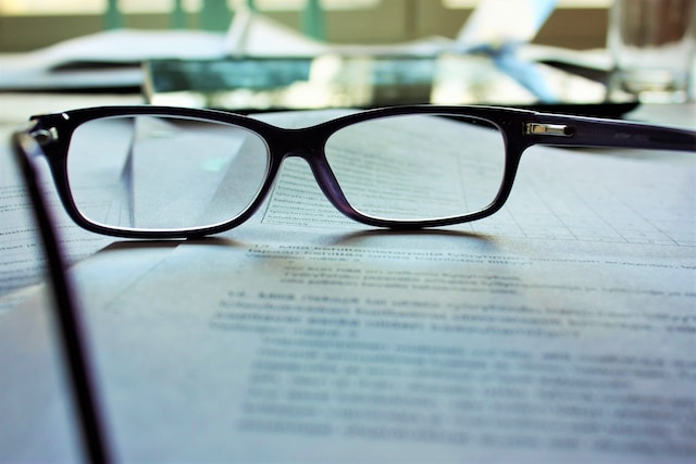 Picture of a pair of spectacles ling on a document