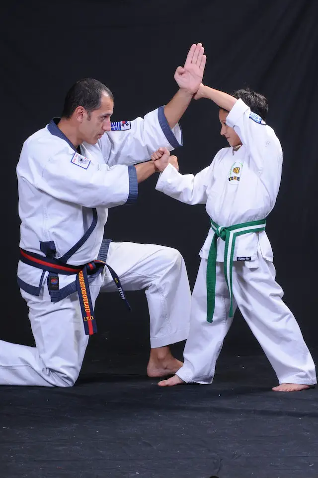 a teacher training a young Tang Soo Do fighter