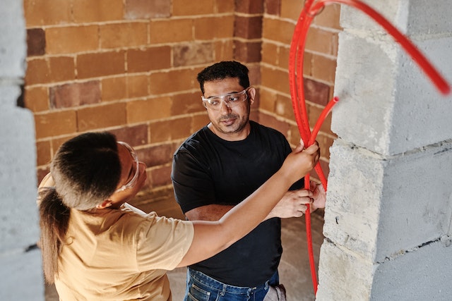 Picture of two men fixing tubing