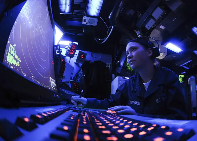 Picture of a navy personal using radar equipment 