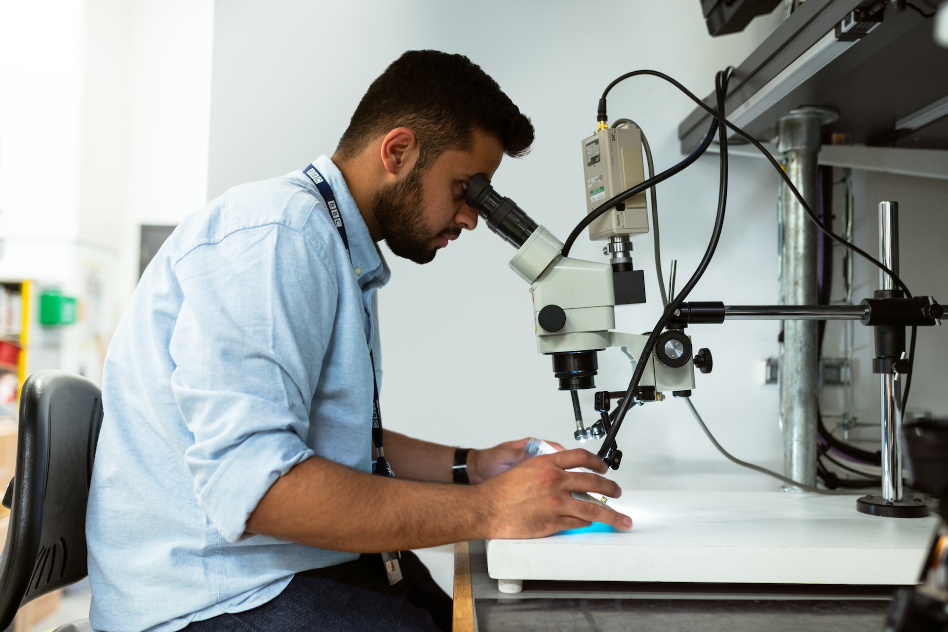 Picture of a man using a metallurgical microscope