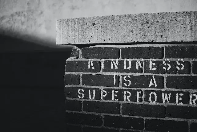 picture of a wall with the words "Kindness is a superpower" written on it