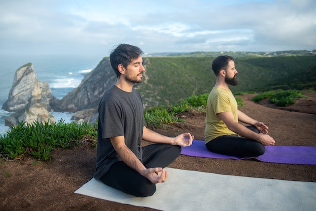 picture of two men doing yoga