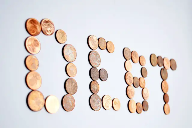 picture of the word "Debt" arranged with coins