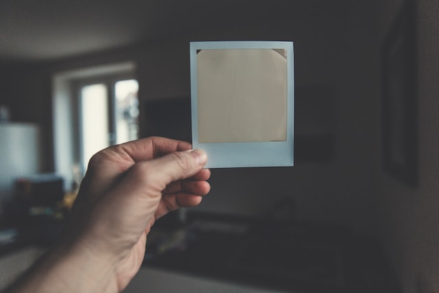 picture of a person holding a polaroid picture
