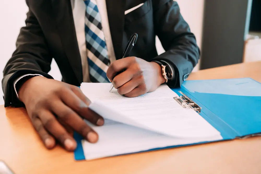 picture of a person signing a legal document 
