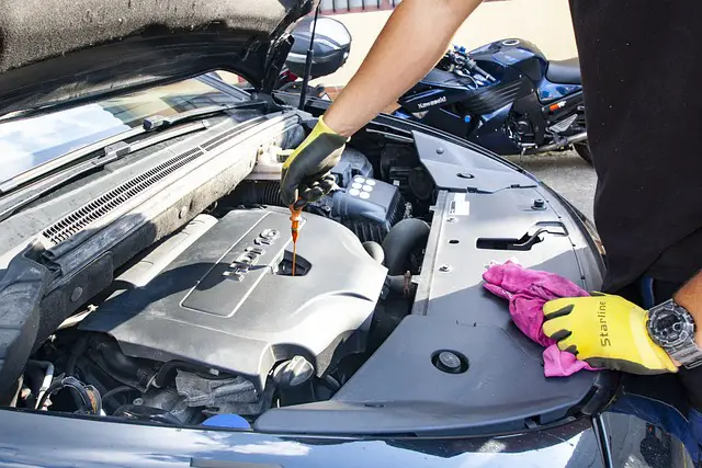 picture of a person checking car oil