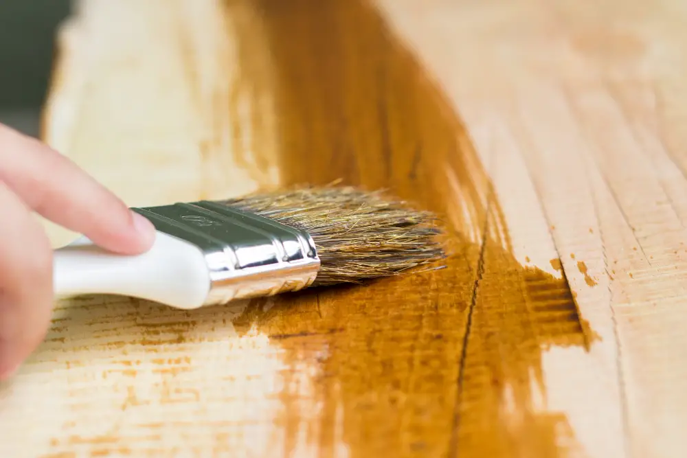 picture of a man painting wood