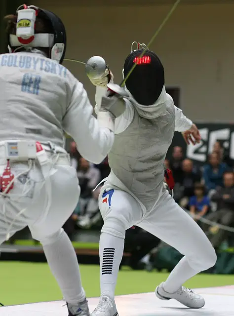 pictures of two persons engaged in fencing  