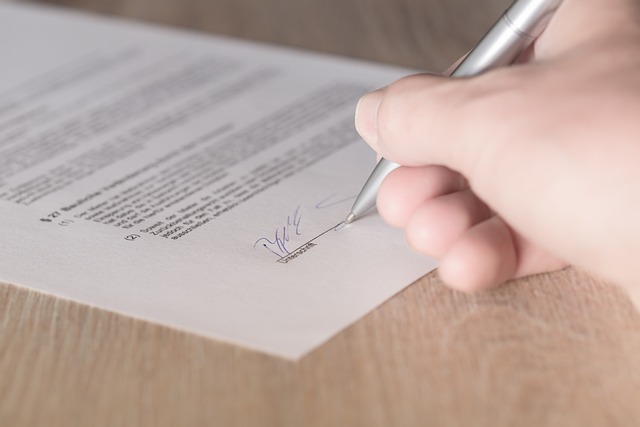 picture of a person signing a lease agreement 