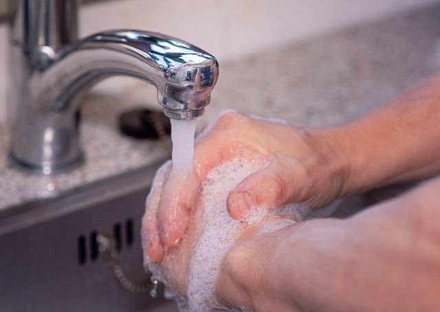 picture of a person sanitizing his hands 