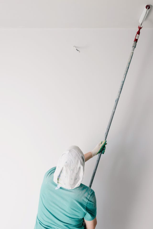 picture of a man painting the ceiling 